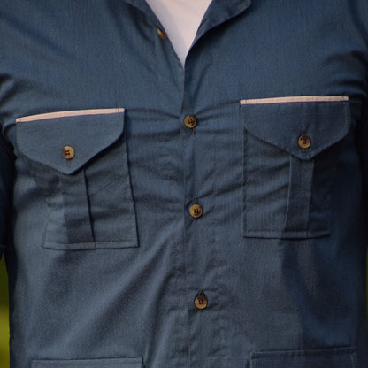 Close-up of a blue shirt with multiple pockets and buttons