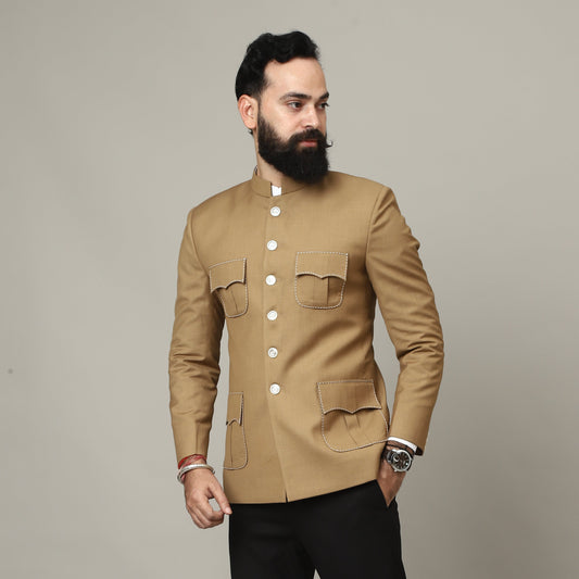 Man wearing a beige jacket and black pants against a plain background