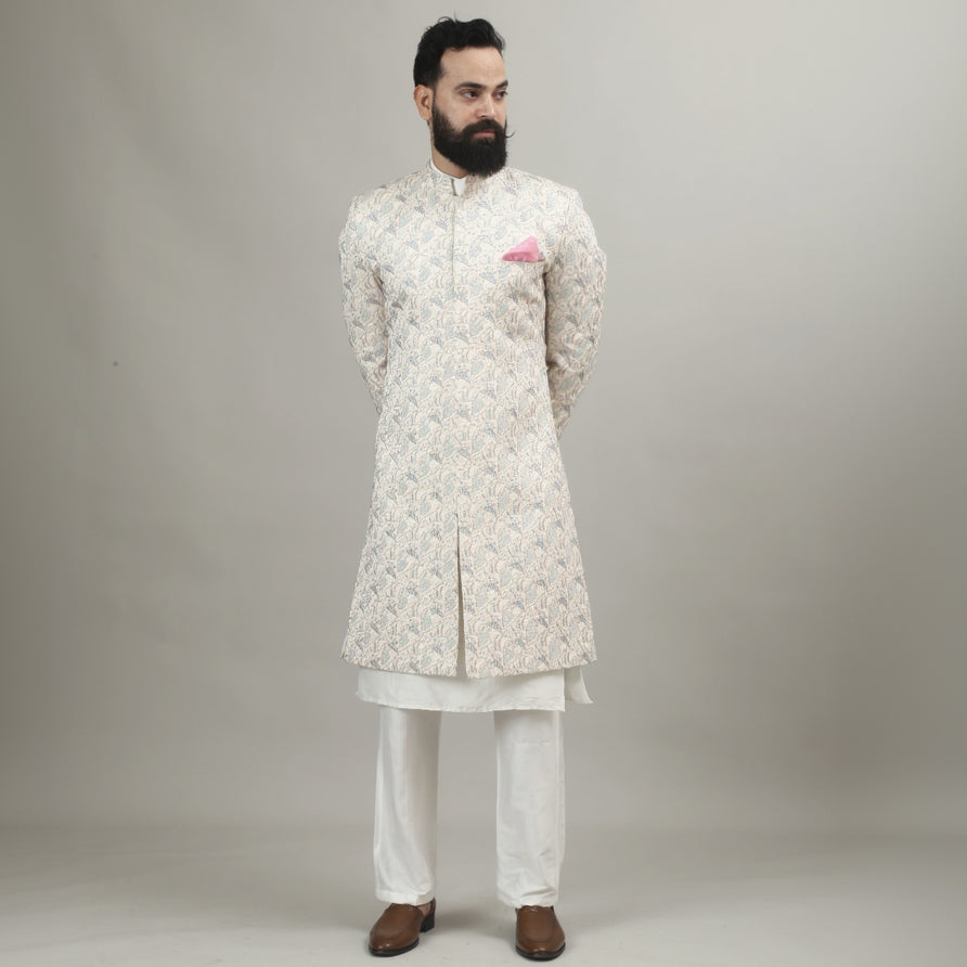 Person wearing a white floral kurta with white pants