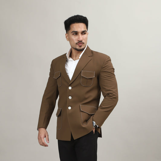 Man wearing a brown coat and black pants on a plain background