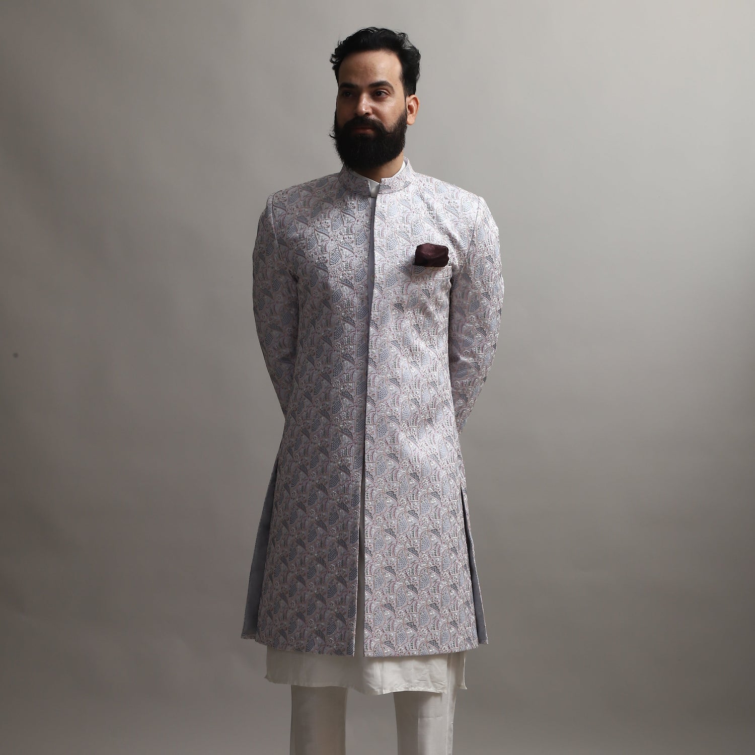 Man wearing a traditional kurta with a patterned jacket